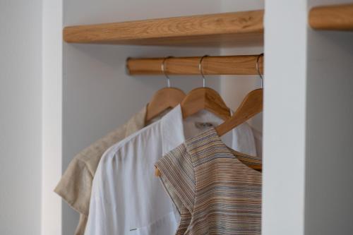 a group of shirts hanging on a rack at Studios Nelli Alonissos in Patitiri