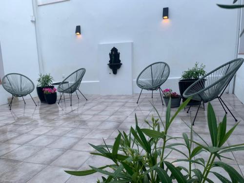 a group of chairs and potted plants in a room at La Rinconada de Perales in Perales de Tajuña