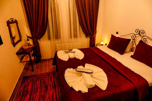 a hotel room with a bed with two towels on it at Ayaz Stone House in Goreme