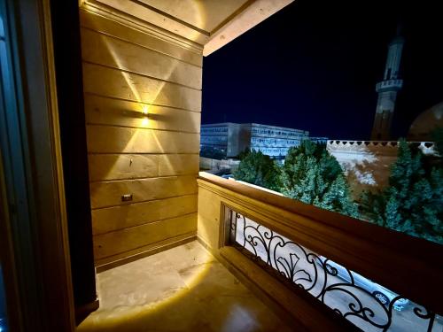 a balcony with a view of a city at night at Fairy appartment in 6th Of October