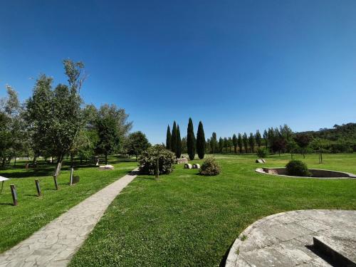 a park with a path in the grass and trees at LeDolciTerme in Rapolano Terme