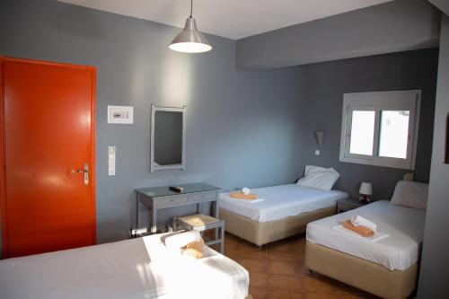 a small room with two beds and a mirror at Villa Preveza Apartments in Preveza