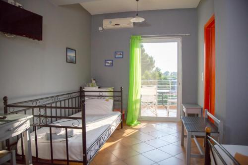 a bedroom with a bunk bed and a sliding glass door at Villa Preveza Apartments in Preveza