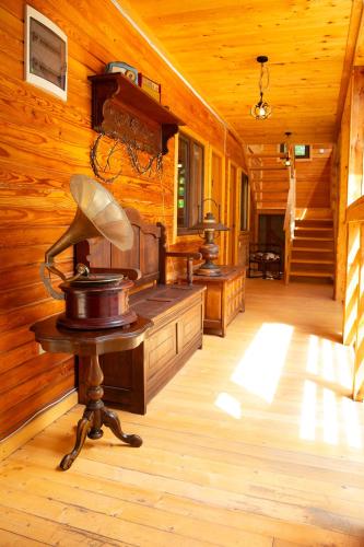 a wooden room with a table with a lamp on it at Casa Decebal in Băile Herculane