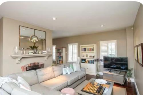 a living room with a white couch and a fireplace at Beautiful home in Thomastown in Thomastown