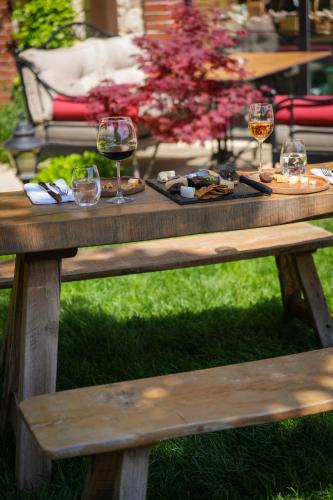a picnic table with wine glasses and food on it at Bengodi Boutique Hotel in Eceabat