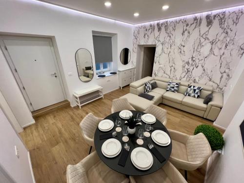 a living room with a table and a couch at Grand Apartment Piran in Piran