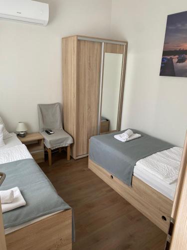 A bed or beds in a room at Csillag Virág Vendégház