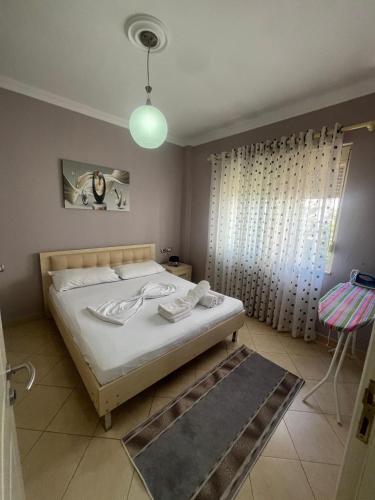 a bedroom with a bed and a window and a lamp at Flower Apartment Golem in Golem