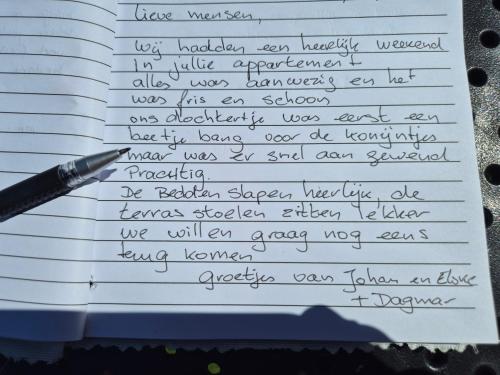a letter written in handwriting with a pen at TIME-OUT met ZONNIG TERRAS, eigen KEUKEN, Dichtbij Dorp, Duinen, Strand en Vuurtoren , Incl verwarmd Hotel-ZWEMBAD in Hollum
