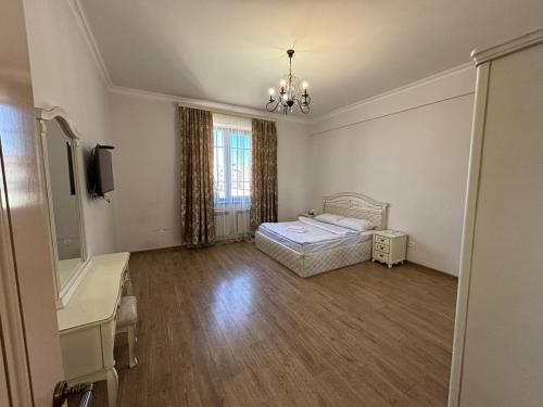 a bedroom with a bed and a desk and a television at Family home AYT in Yerevan