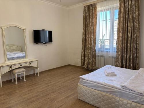a hotel room with a bed and a mirror at Family home AYT in Yerevan