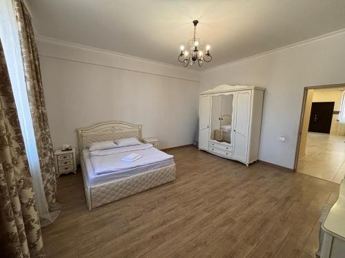 a bedroom with a bed and a dresser in it at Family home AYT in Yerevan