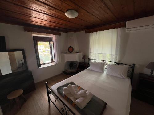 a bedroom with a bed with two towels on it at Xlimos house in Ayía Kiriakí