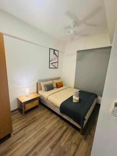 a small bedroom with a bed and a table at Agile TRX Luxury suite Bukit bintang in Kuala Lumpur