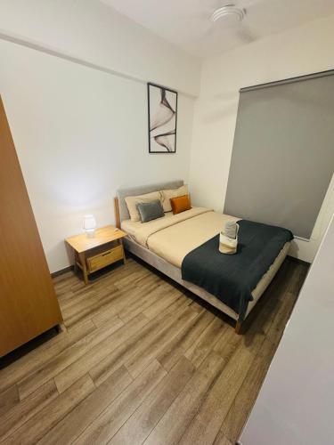 a small bedroom with a bed and a table at Agile TRX Luxury suite Bukit bintang in Kuala Lumpur