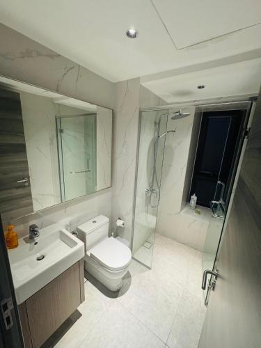 a bathroom with a toilet and a sink and a shower at Agile TRX Luxury suite Bukit bintang in Kuala Lumpur