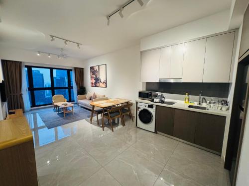 a kitchen and living room with a table and a dining room at Agile TRX Luxury suite Bukit bintang in Kuala Lumpur