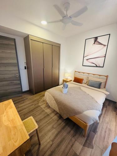 a bedroom with a large bed and a table at Agile TRX Luxury suite Bukit bintang in Kuala Lumpur