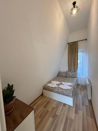 a small bedroom with a bed in a attic at A Frame village in Mekhrably