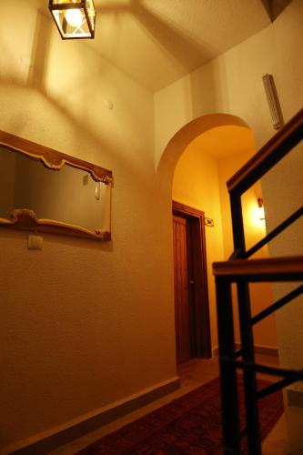 a room with a mirror on the wall and a door at Ayaz Stone House in Goreme