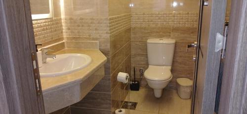 a bathroom with a toilet and a sink at Sharm hills sea view in Sharm El Sheikh