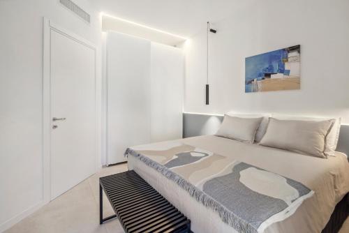 a white bedroom with a bed and a window at Casa Matilde in Baveno