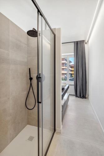 a walk in shower with a glass door at Casa Matilde in Baveno