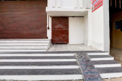 a door with stairs in front of a building at Hotel O Stay Inn in Patna