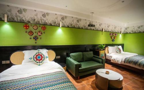 a room with two beds and a green wall at Ancient Road Yunju in Kashgar