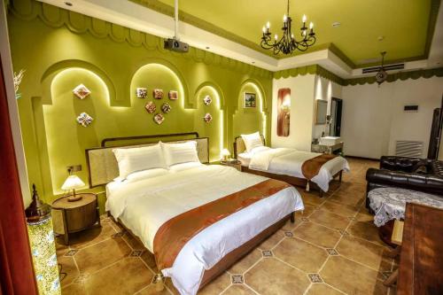 a large bedroom with two beds and a couch at Ancient Road Yunju in Kashgar