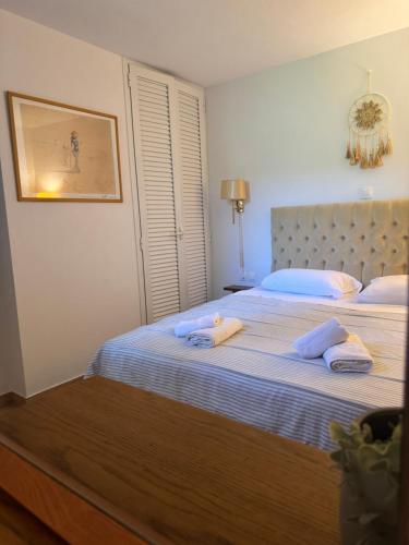 a bedroom with two beds with towels on them at Beko Corfu house in Gouvia