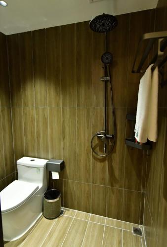 a bathroom with a toilet and a shower at Ancient Road Yunju in Kashgar
