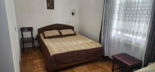 a small bedroom with a bed and a window at Miriani - მირიანი in Sighnaghi