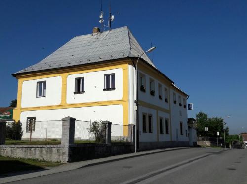 a yellow and white building with a roof at Restaurace 96 in Košice