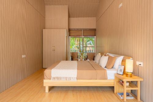 a bedroom with a large bed and a window at StayVista at Silver Slopes with outdoor pool in Chandīgarh