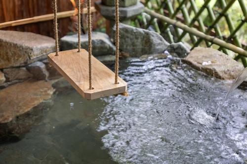 a swing in a water feature with a waterfall at Nazuna Hakone Miyanosita in Miyanoshita