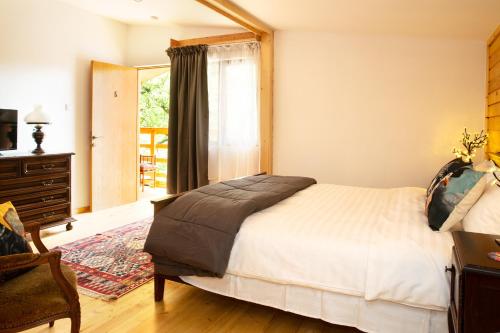 a bedroom with a large bed and a window at Casa Decebal in Băile Herculane