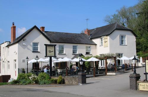a large white building with a clock in front of it at The Malvern Hills Hotel in Great Malvern