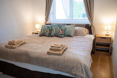 a bedroom with a bed with towels on it at Bella Apartman in Nyíregyháza