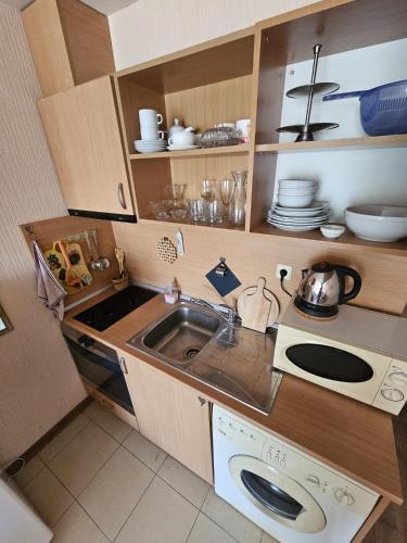 a small kitchen with a sink and a stove at Julia Vigo Panorama apartments in Nesebar