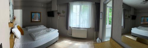 Un ou plusieurs lits dans un hébergement de l'établissement Hotel Gaudi