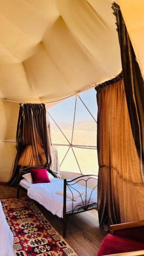 a bedroom with two beds in a tent at Wadi Rum Luxure desert Camp in Wadi Rum