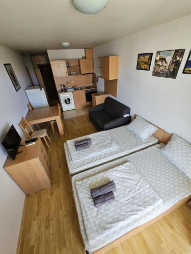 a living room with two beds and a couch at Julia Vigo Panorama apartments in Nesebar
