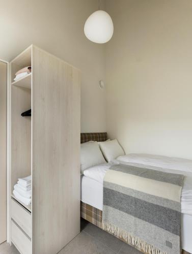 a small bedroom with a bed and a closet at Heiðin Homes Villas in Akureyri