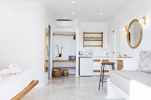 a white living room with a white couch and a kitchen at Dream on Plaka in Plaka