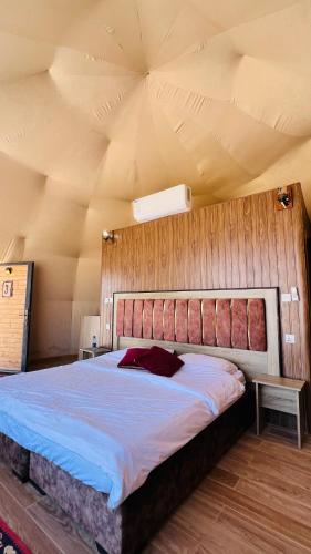 a bedroom with a large bed in a room at Wadi Rum Luxure desert Camp in Wadi Rum