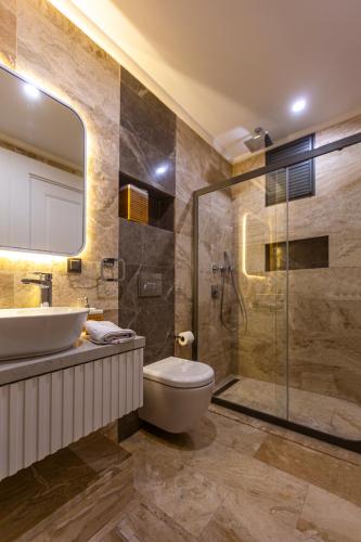 a bathroom with a sink and a toilet and a shower at Marje Villas Bodrum in Bodrum City