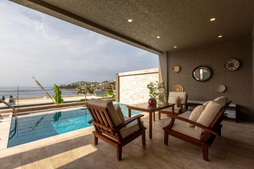 a living room with a pool and a table and chairs at Marje Villas Bodrum in Bodrum City