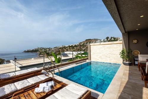 a pool on the roof of a house with a view at Marje Villas Bodrum in Bodrum City